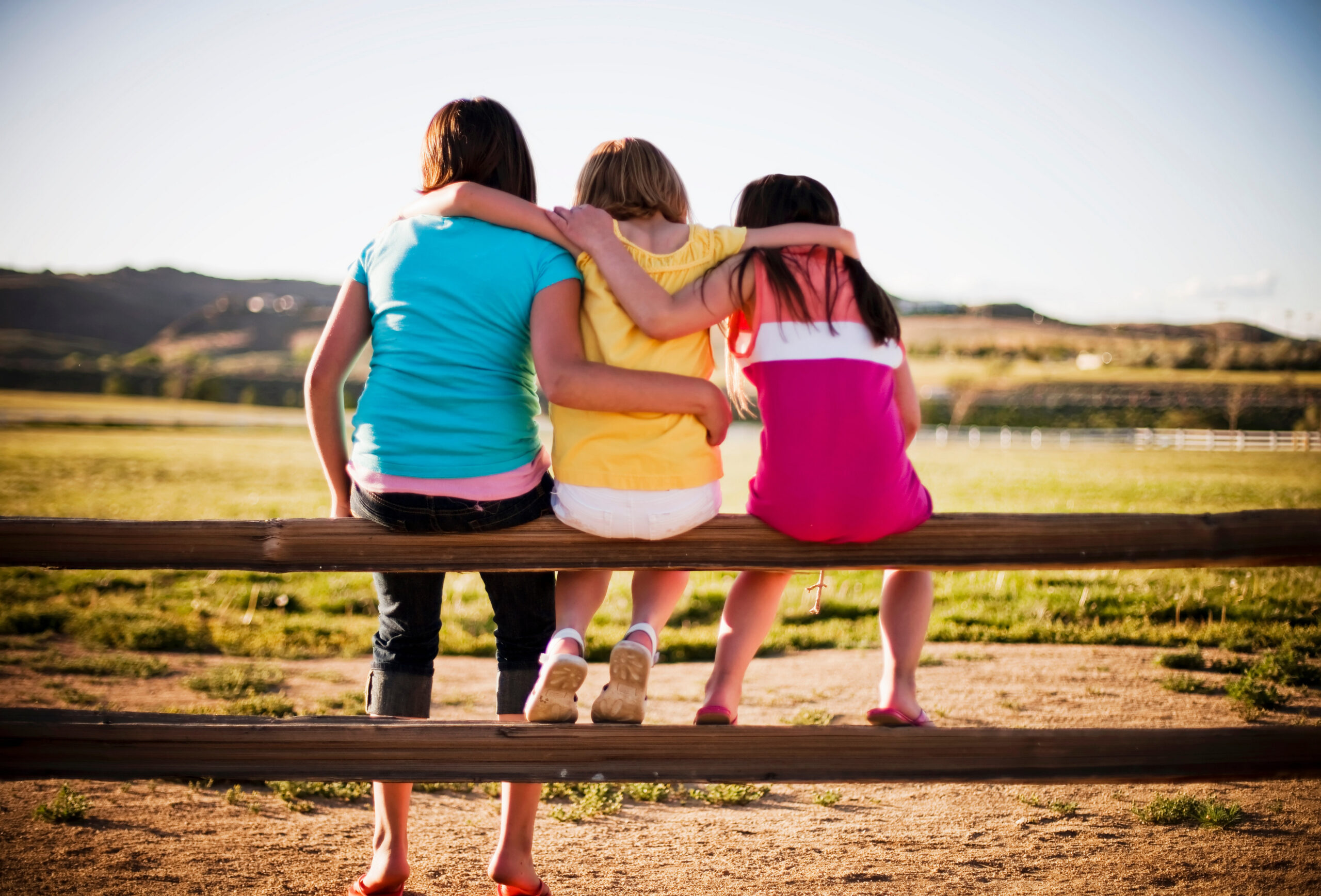 Discipling Teens: Where Correction Meets Grace 3 young girls sitting on fence